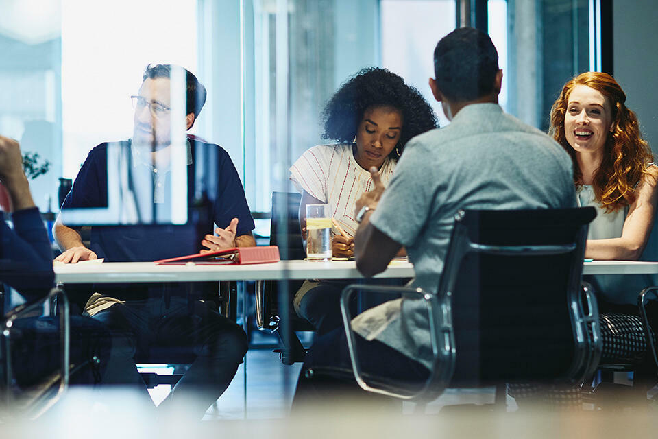 people working in an office boardroom